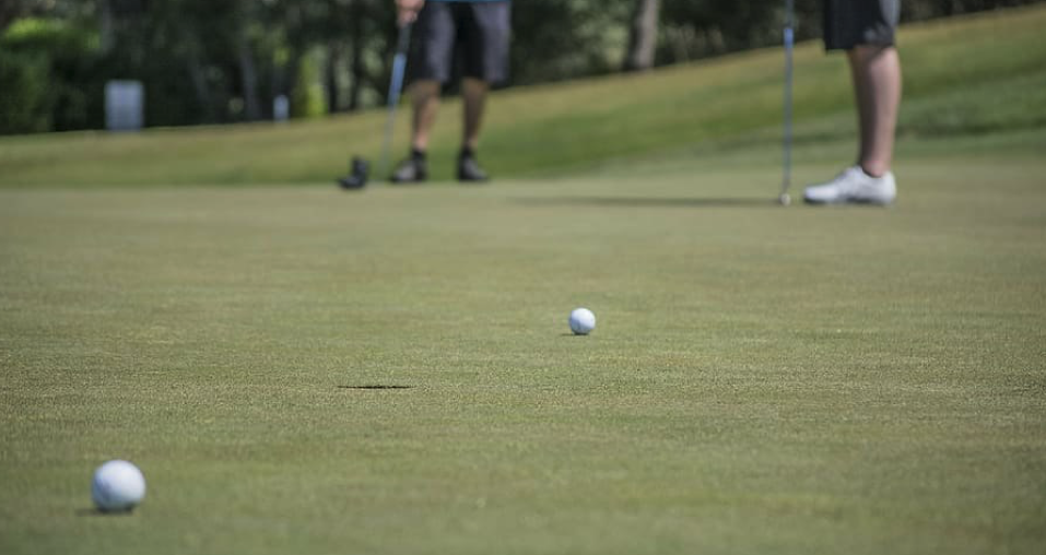  Image showing two balls on the golf course near the hole representing one of the popular golf point game, Scotch