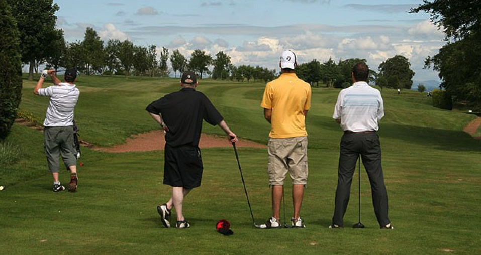 Image showing four golf players, one is seen playing his shot and three other playing are seen watching his shot from behind representing one of the popular golf point games Aces and deuces