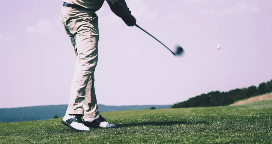 Blog image: Low angle view of a golfer playing his shot to support the article “3 fun and exciting golf games to play; Match Play, Round Robin, and Four-ball.