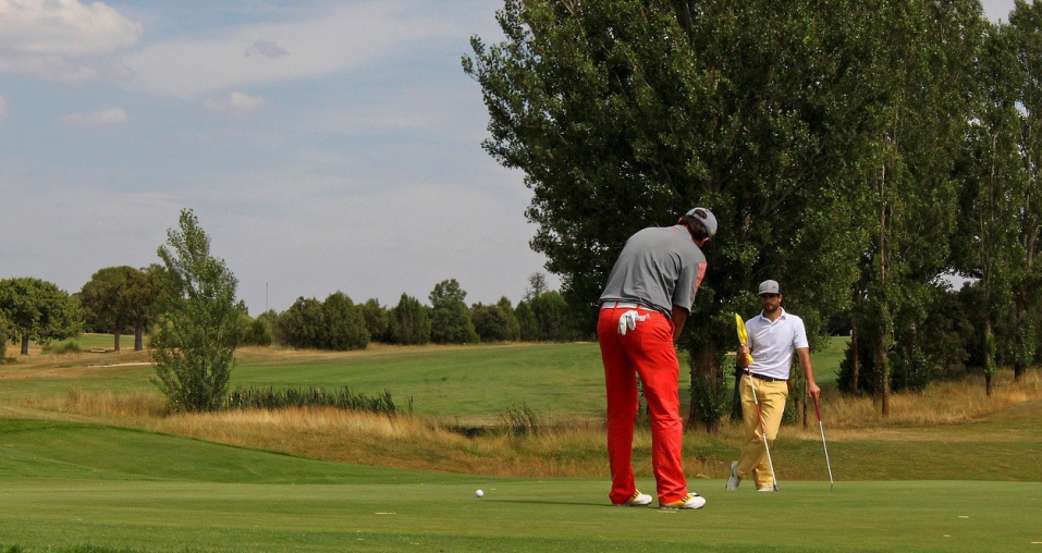 Two golfers playing golf representing the Four-ball golf game 