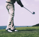 Blog image: Low angle view of a golfer playing his shot to support the article “3 fun and exciting golf games to play; Match Play, Round Robin, and Four-ball.