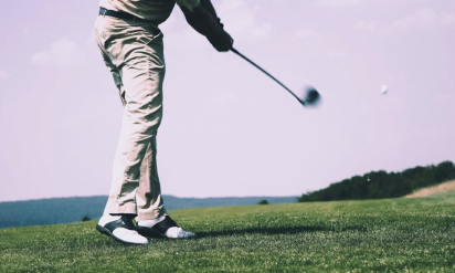 Blog image: Low angle view of a golfer playing his shot to support the article “3 fun and exciting golf games to play; Match Play, Round Robin, and Four-ball.