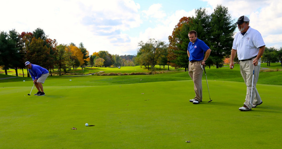 Golf player hoping to make the put and win the golf game bet