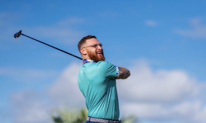 Follow through of a golfer after hitting the ball